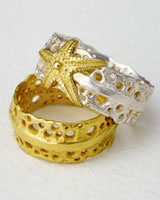 'Two Pierced Rings' one in gold and one in silver with gold starfish